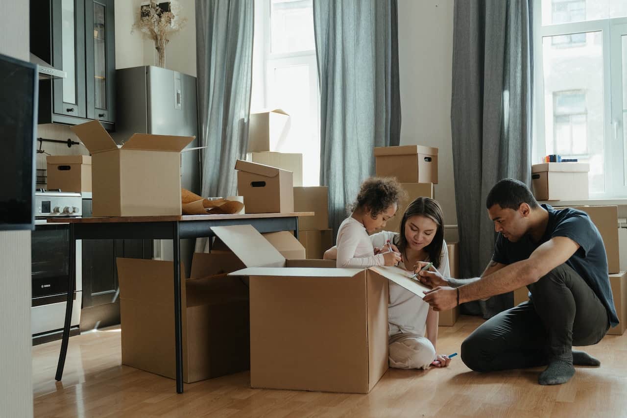 family surrounded by moving boxes