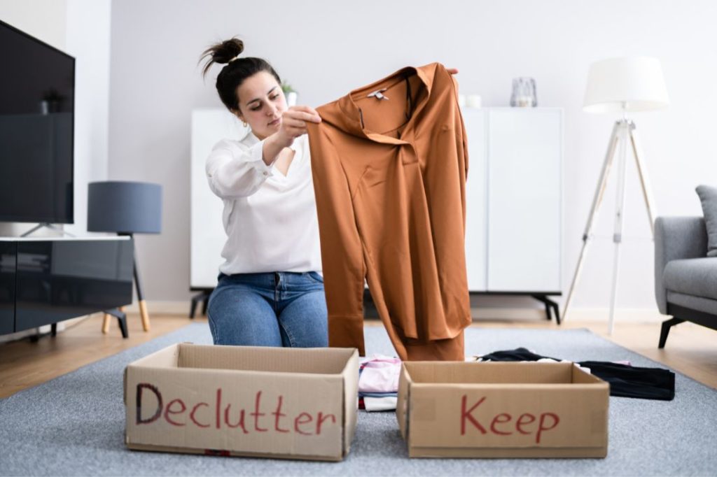 Woman Decluttering Belongings Before Moving Day 