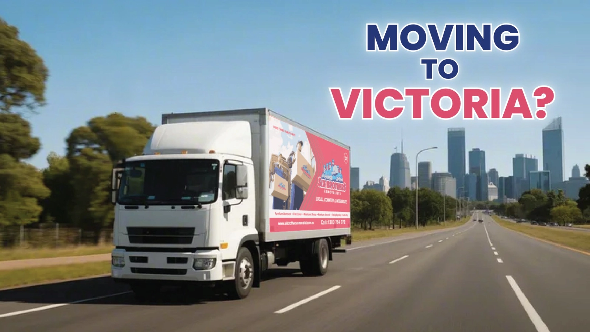 Removalist truck driving on highway toward city skyline with urban buildings in the distance.